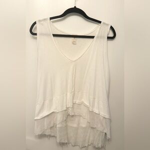 We the Free. White sleeveless top. Tattered edge flowy bottom.